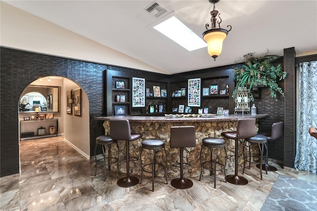 bar featuring vaulted ceiling