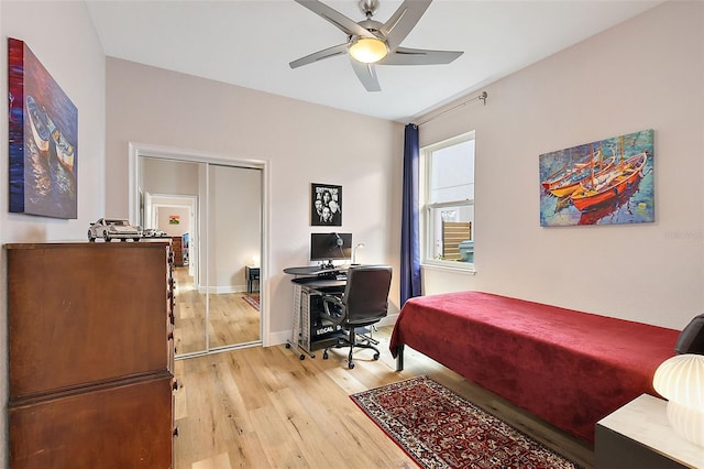 bedroom featuring ceiling fan, light hardwood / wood-style floors, and a closet