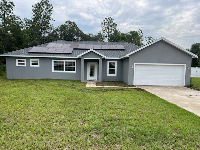 ranch-style house featuring a garage, a front lawn, and solar panels