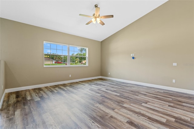 empty room with hardwood / wood-style flooring, high vaulted ceiling, and ceiling fan