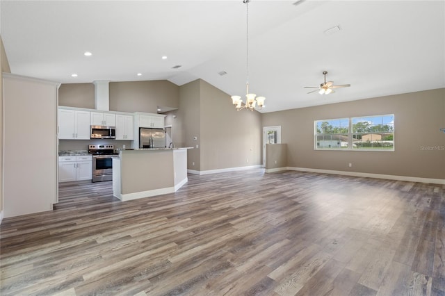 kitchen with appliances with stainless steel finishes, decorative light fixtures, an island with sink, and hardwood / wood-style floors