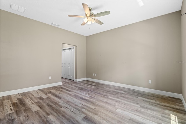 unfurnished room with ceiling fan and hardwood / wood-style flooring