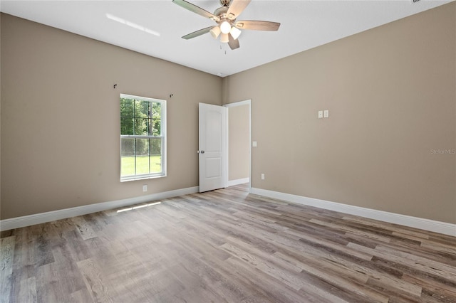 empty room with ceiling fan and hardwood / wood-style floors