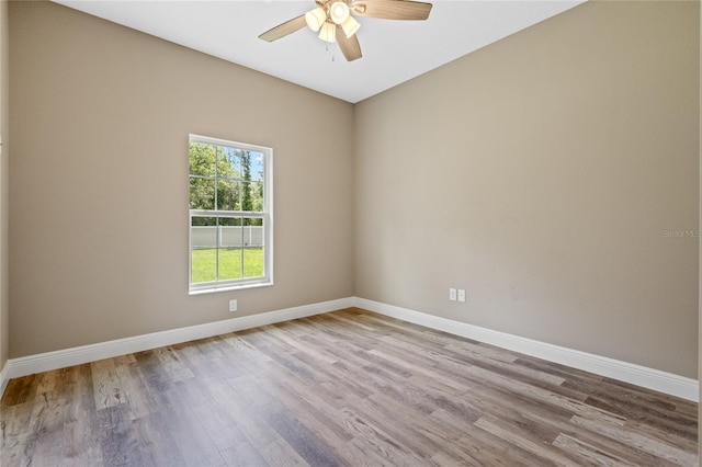 unfurnished room with ceiling fan and hardwood / wood-style floors