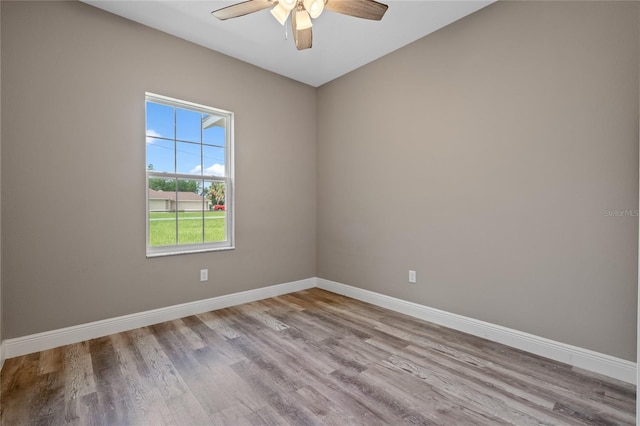 unfurnished room with ceiling fan and hardwood / wood-style flooring