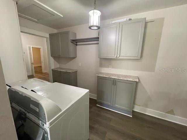 laundry area with dark hardwood / wood-style flooring and independent washer and dryer