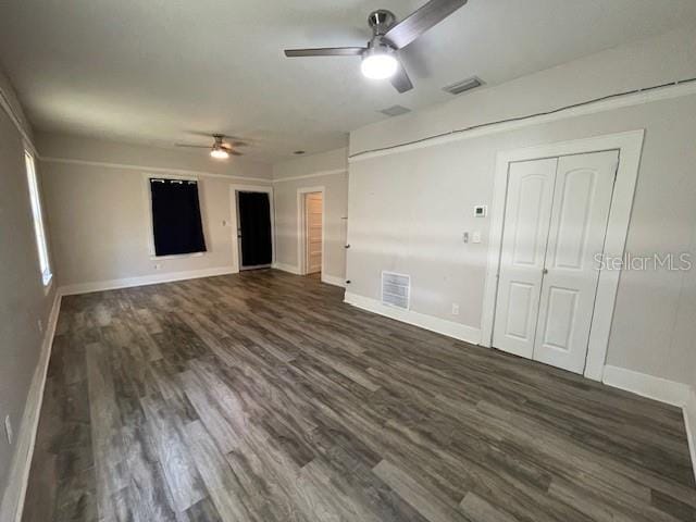 unfurnished room with ceiling fan and dark hardwood / wood-style floors