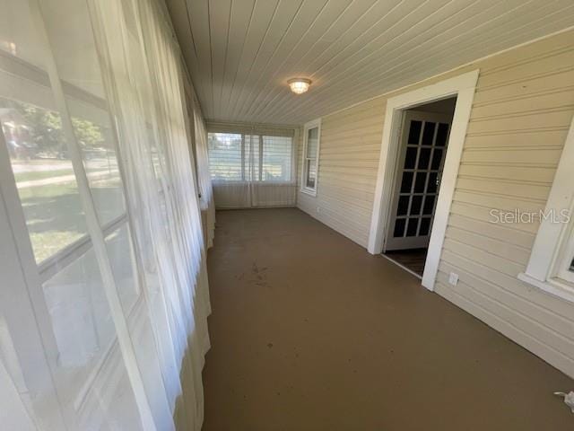 unfurnished sunroom with wooden ceiling