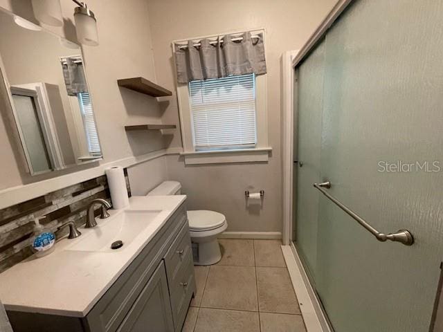 bathroom with backsplash, an enclosed shower, vanity, and tile patterned flooring