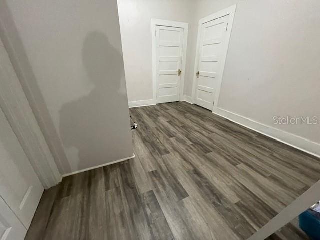 spare room with dark hardwood / wood-style floors