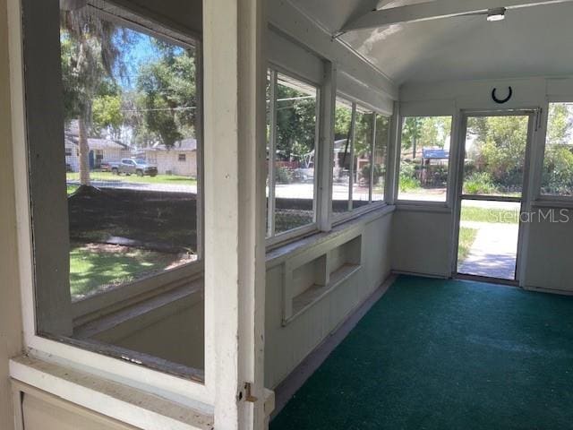 sunroom / solarium featuring lofted ceiling