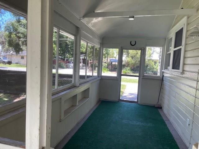 unfurnished sunroom with lofted ceiling and plenty of natural light