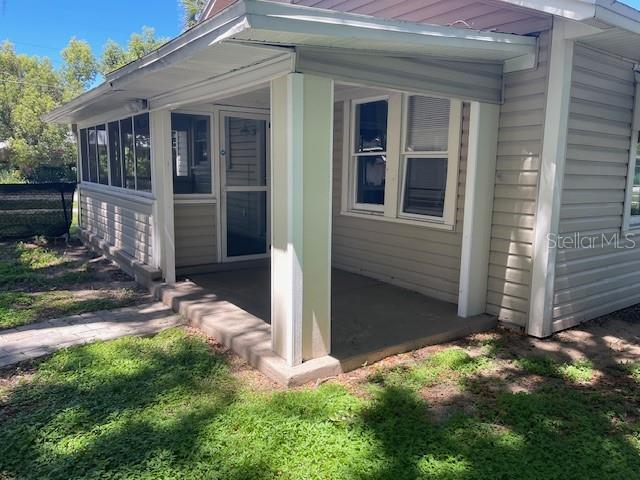 view of property exterior with a sunroom