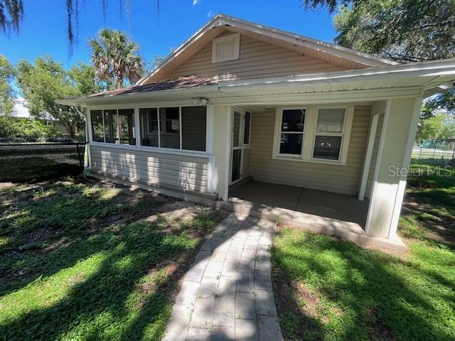 view of front of house with a sunroom