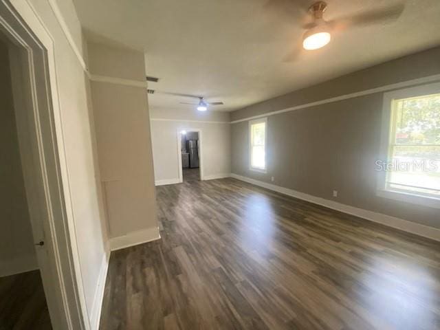 unfurnished room with ceiling fan and dark hardwood / wood-style floors