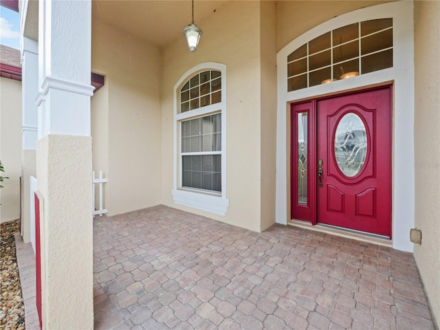 view of exterior entry with a porch