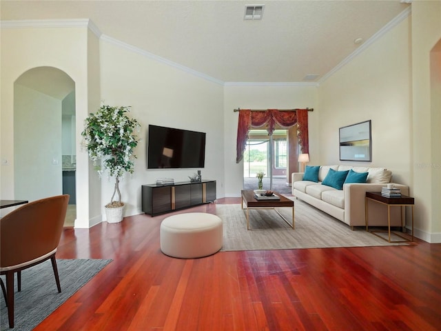 living room featuring hardwood / wood-style flooring and ornamental molding