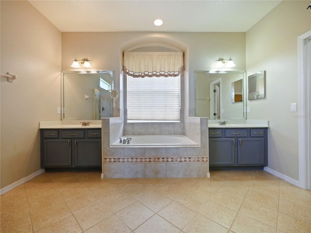 bathroom with vanity, tiled bath, and tile patterned floors