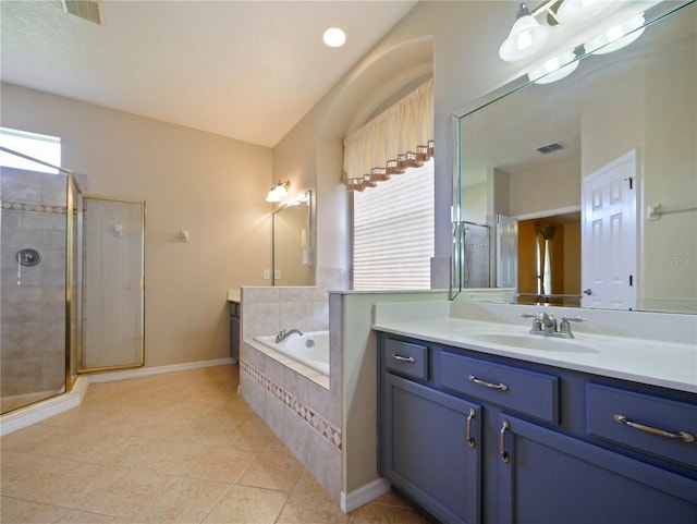 bathroom with tile patterned floors, vanity, and separate shower and tub