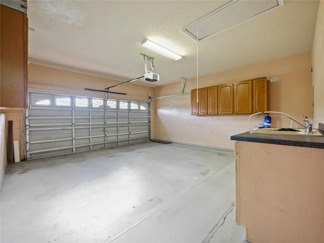 garage with sink and a garage door opener