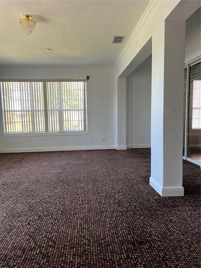 unfurnished room with crown molding and a textured ceiling