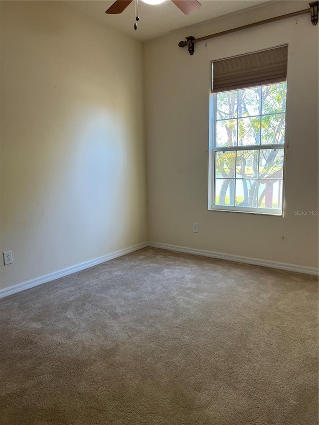 carpeted empty room with ceiling fan