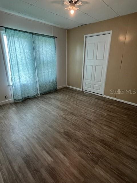 spare room with ceiling fan and dark hardwood / wood-style floors