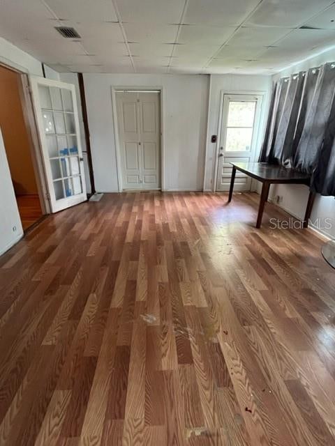 hallway with hardwood / wood-style flooring