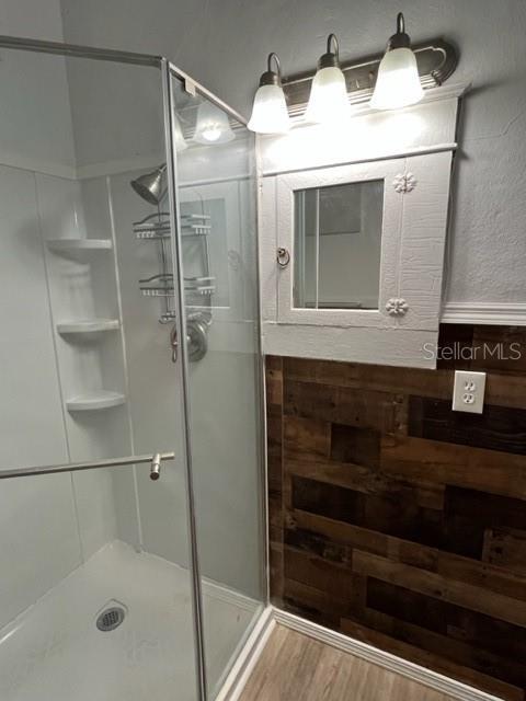 bathroom featuring hardwood / wood-style floors and walk in shower