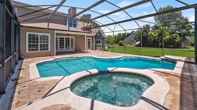 view of swimming pool featuring a lawn, glass enclosure, ceiling fan, an in ground hot tub, and a patio