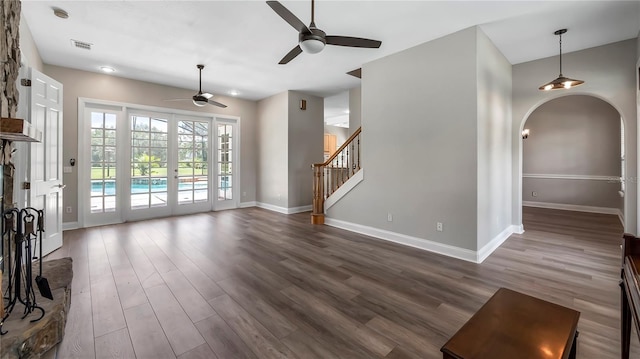 living room featuring wood-type flooring, french doors, and ceiling fan