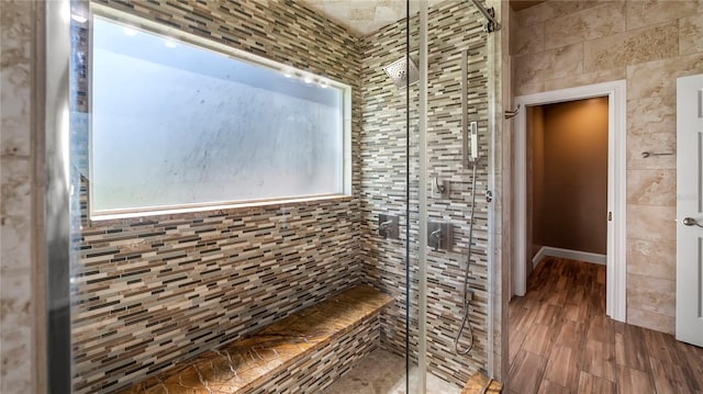 bathroom featuring tiled shower and hardwood / wood-style floors