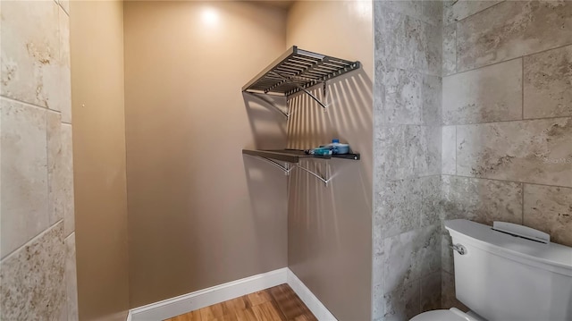 bathroom featuring hardwood / wood-style floors and toilet