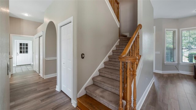 stairway with hardwood / wood-style floors