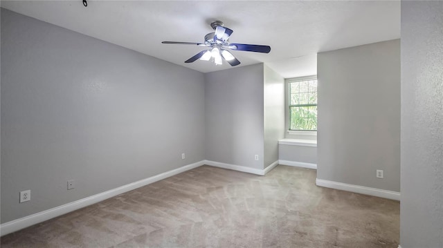 spare room featuring ceiling fan and light colored carpet