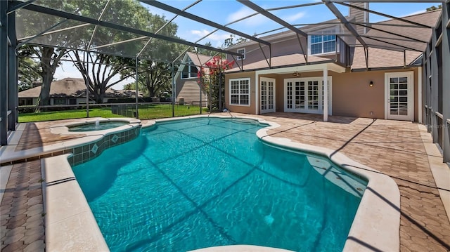 view of swimming pool featuring glass enclosure, ceiling fan, french doors, a patio area, and an in ground hot tub