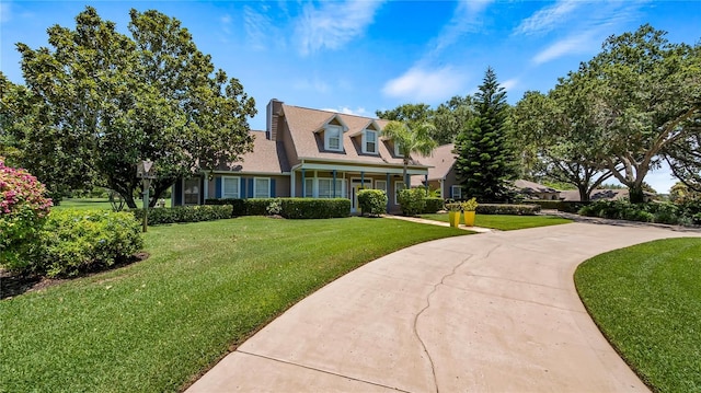 cape cod house featuring a front yard