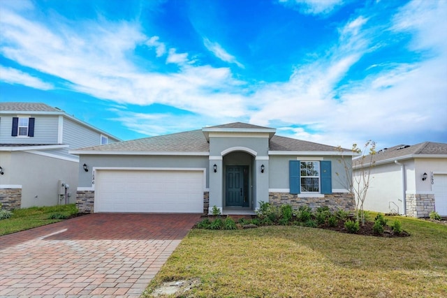 view of front of home with a front lawn and a garage