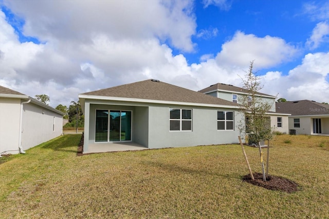 rear view of property featuring a yard