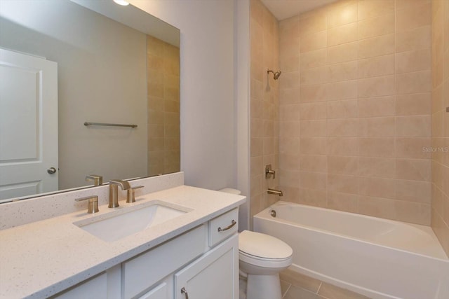 full bathroom with tile patterned flooring, vanity, tiled shower / bath combo, and toilet