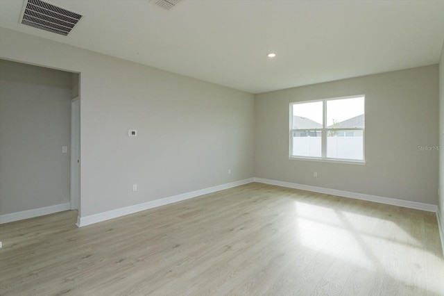 empty room with light hardwood / wood-style floors