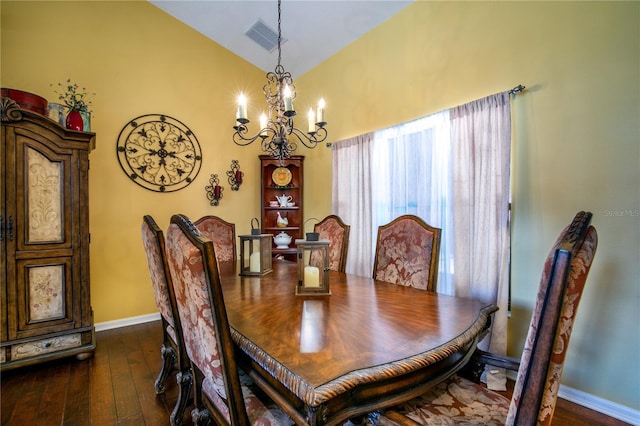 dining space with a notable chandelier, dark wood-type flooring, and high vaulted ceiling