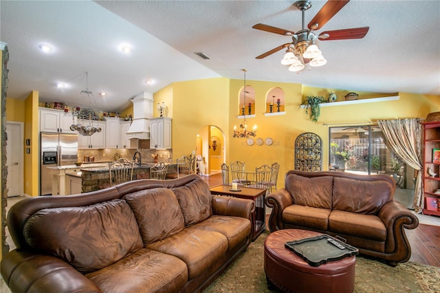 living room featuring dark hardwood / wood-style flooring, ceiling fan with notable chandelier, a textured ceiling, sink, and high vaulted ceiling