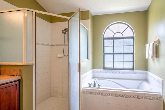 bathroom with vanity and independent shower and bath