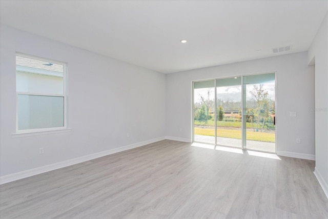 empty room with light hardwood / wood-style floors