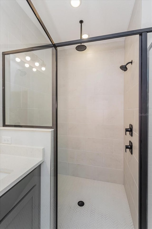 bathroom featuring vanity and an enclosed shower