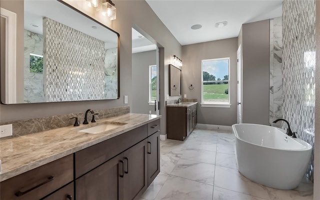 bathroom featuring vanity and a bath