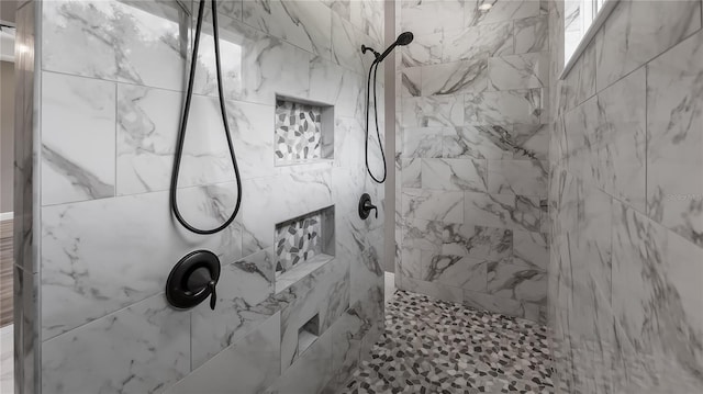 bathroom with a tile shower