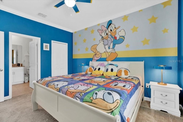 bedroom with carpet, visible vents, ensuite bath, a closet, and crown molding