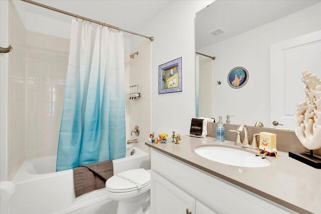 full bathroom featuring shower / bathtub combination with curtain, vanity, and toilet